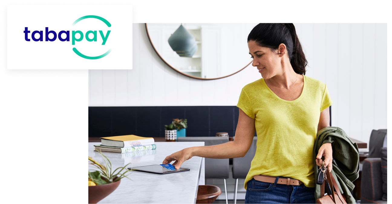 tabapay logo, over image of person picking up their card from a tablet on a counter top